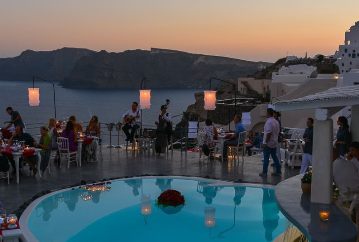 andronisgastronomy_santorini | Instagram | Andronis Luxury Suites hosts an annual culinary celebration amidst iconic blue-domed chapels.